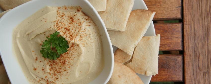 Hummus and pita bread, with dusting of paprika and herb.