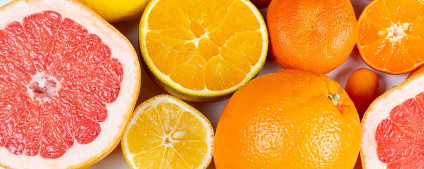 Set of different citrus fruits on a white background, top view