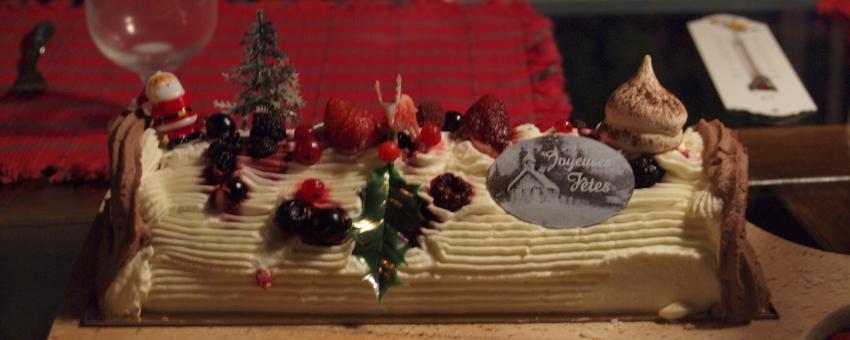 A traditional French bûche de Noël (Yule log cake) bought from a small bakery in Colomars, Alpes-Maritimes, France, served at a Christmas eve dinner.