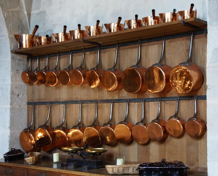collection of copper saucepans in kitchen of Vaux-le-Vicomte castle
