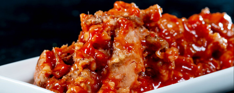 Fish with tomato sauce on a white plate