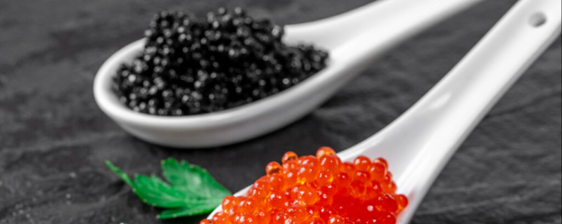 Red and black caviar on a black stone tray